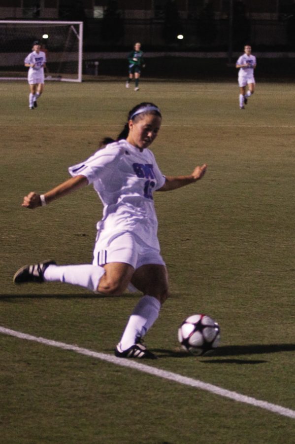 Midfielder Leslie Briggs crosses the ball in the Mustangs game against UNT last month. CASEY LEE/The Daily Campus