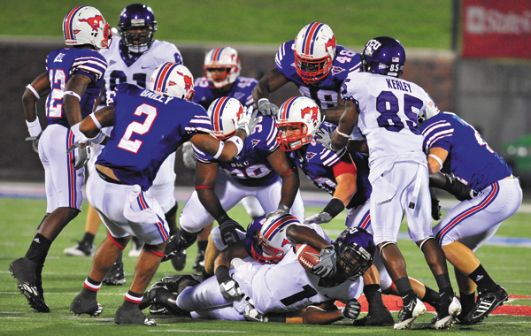 A pack of Mustang defenders tackle a TCU running back in last years Battle for the Iron Skillet. STUART PALLEY/The Daily Campus