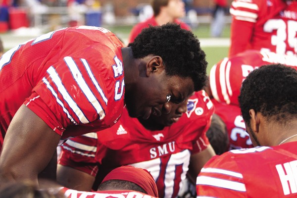 Junior linebacker Youri Yenga leads the team in prayer after the Mustangs defeated the Tulane Green Wave.