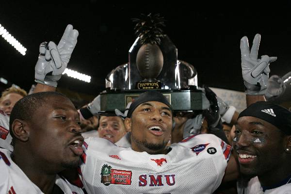 SMU teammates hoist the Hawaii Bowl trophy after SMU defeated Nevada 45-10 at the Hawaii Bowl NCAA college football game, Thursday, Dec. 24, 2009, in Honolulu. 
