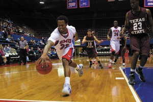 SMU guard Paul McCoy saves an out-of-bounds ball during a game against Texas State Wednesday night in Moody Coliseum.