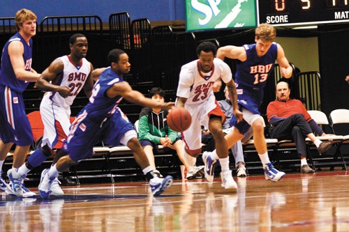 SMU guard Paul McCoy steals a loose ball on defense against Houston Baptist January 23 at Moody Coliseum. SMU won the game 82-68. 