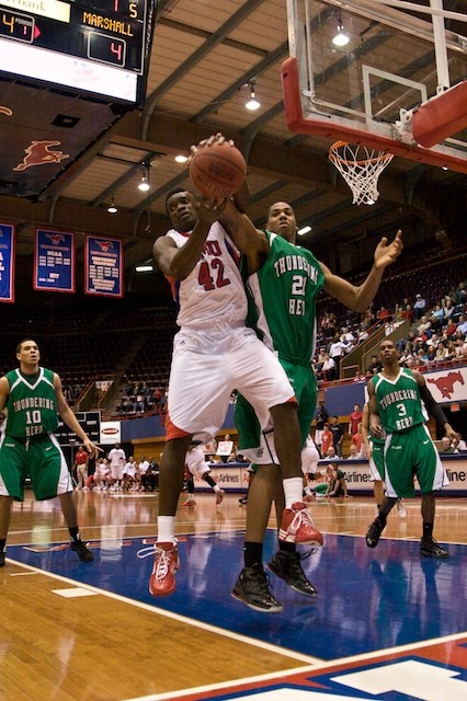 SMU forward Papa Dia fights for a rebound against an opposing player from the Marshall Thundering Herd.