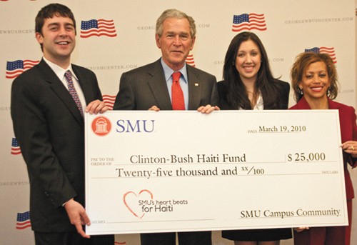 Student Body President Patrick Kobler, International Relations executive council member Rachel Carey, and Vice President for Student Affairs Lori White stand with former President George W. Bush Friday. Members of the SMU community raised $25,000 and presented it to the Clinton-Bush foundation to support Haitian earthquake relief.