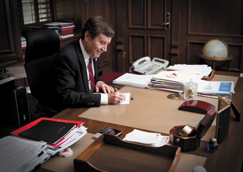 SMU President R. Gerald Turner working at his desk in the Presidential Office.