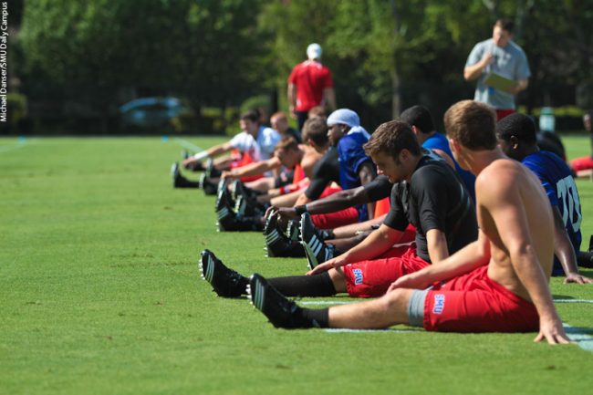 Members of the SMU football team stretch during their first practice of the 2010 season Saturday morning.