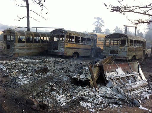 In this photo provided by Eric Peter Abramson, a line of buses are destroyed after a wild fire passed through Gold Hill, Colo. on Tuesday, Sept. 7, 2010. Gov. Bill Ritter declared a state of emergency Tuesday as officials nearly doubled the fires estimated size to more than 7,100 acres, or 11 square miles. At one point the plume from the fire could be seen in Wyoming, 90 miles to the north