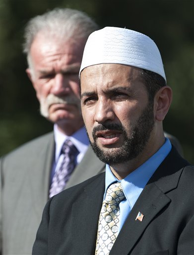 Imam Muhammad Musri of the Islamic Society of Central Florida, right, speaks to the media as Pastor Terry Jones of the Dove World Outreach Center looks, Thursday, Sept. 9, 2010, in Gainesville, Fla.