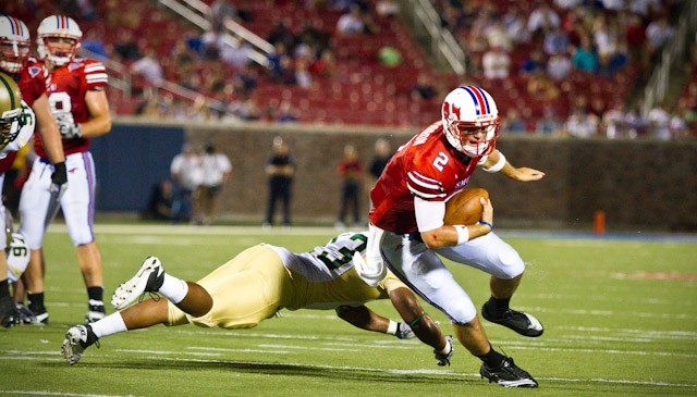 SMU quarterback Kyle Padron dodges a tackle by UAB Linebacker Keon Harris during play at Ford Stadium Saturday night. SMU won the game 28-7.