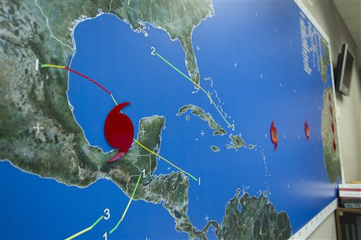 The wall map at the National Hurricane Center in Miami shows the location of hurricanes Karl, Igor and Jula Thursday, Sept. 16, 2010. Karl has become a hurricane in the Gulf of Mexico after dumping heavy rains on the Yucation Peninsula as a tropical Storm. In the Atlantic, Igor spun into a dangerous Category 4 storm that could bring dangerous rip currents to the U.S. East Coast. On the other side of the Atlantic, Julia briefly intensified into a powerful Category 4 storm before weakening to a Ca