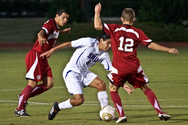SMU midfielder Josue Soto attempts to dribble past South Carolina midfielder Chipper Root during play Wednesday evening at Wescott Field. SMU won the match 3-1.