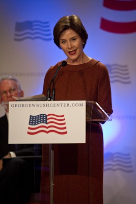 Former First Lady Laura Bush announces her “Alliance to Reform Education Leadership” initiative Wednesday morning at North Dallas High School, as George W. Bush Institute Executive Director James Glassman listens in the background.