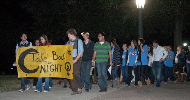 SMU students march across campus last night in the Take Back the Night event to raise awareness against sexual abuse Monday evening.