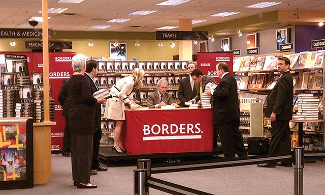 Former President George W. Bush signs copies of his memoir, “Decision Points,” Tuesday at Borders Bookstore in the Preston Oaks Shopping Center.