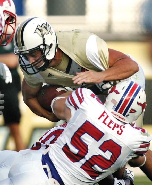 Former Central Florida quarterback Michael Greco runs on a fourth and one yard for a first down past SMU line backer Pete Fleps during play in Orlando, Fla., Saturday, Oct. 4, 2008. SMU faces UCF in the C-USA Championship Game Saturday in Orlando.