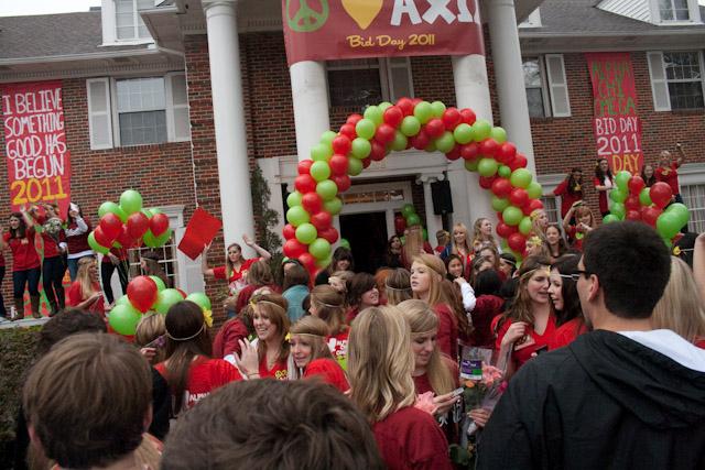 Members of the Alpha Chi Omega sorority and freshman pledges gather to celebrate outside of the Chi Omega sorority house Sunday morning as part of the panhellenic councils Bid Day.
