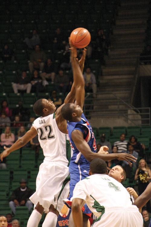 University of Alabama at Birmingham forward Cameron Moore contests the opening tip off with SMU forward Papa Dia during play Wednesday evening inside Bartow Arena in Birmingham. UAB won the match 67-53. 
