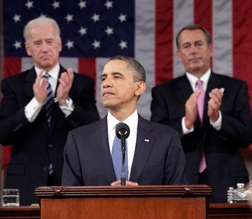 President Barack Obama is applauded by Vice President Joe Biden and House Speaker John Boehner on Capitol Hill in Washington, Tuesday, while delivering his State of the Union address.