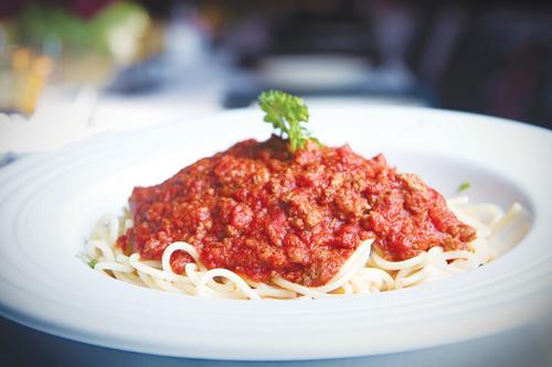 Angelo’s spaghetti with meat sauce, pictured, has a sweet sauce with a hearty texture of meat and fresh tomatoes, making an ideal comfort food.