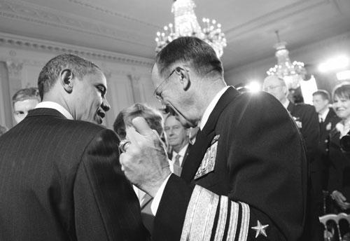President Barack Obama speaks with Joint Chefs Chairman Adm. Mike Mullen, in  the East Room of the White House in Washington, Jan. 24, 2011, after announcing new government-wide initiatives to support military families, including programs aimed at preventing suicide and eliminating homelessness.