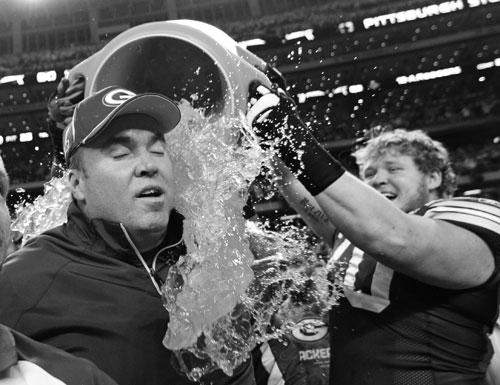 Green Bay Packers head coach Mike McCarthy is dunked with Gatorade by T.J. Lang after their 31-25 victory over the Pittsburgh Steelers in the NFL football Super Bowl XLV game Sunday, in Arlington.