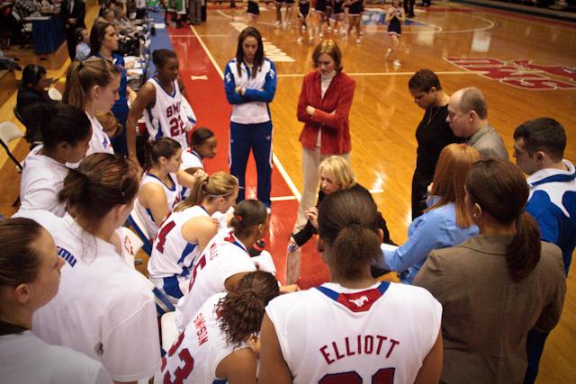 SMU Head Coach Ronda Rompola speaks with members of the team during a timeout Thursday evening inside Moody Coliseum. SMU won the game 62-46.