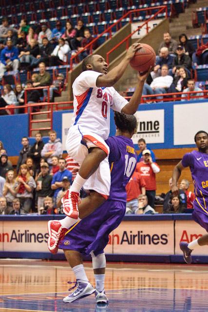 SMU guard Rodney Clinkscales attempts a layup over ECU guard Brock Young during play Feb. 2 inside Moody Coliseum.