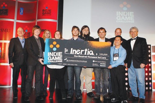SMU Guildhall graduate students, Evan Skarin (from left) Michelle Hayden, John Bevis, Brandon Stephens, William Swannack, and Wayland Fong receive the Indie Game Challenge award for their video game,  “Inertia,” on Jan. 20.