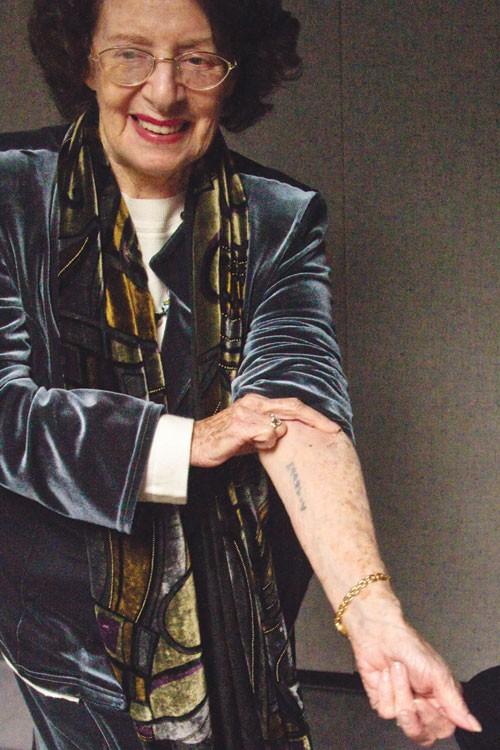Holocaust survivor Agi Geva shows a serial number tattooed on her left forearm during a lecture Monday evening which was given to Auschwitz concentration camp detainees selected for forced labor.