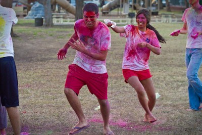SMU student Anisha Chandra attempts to throw water on Asad Berani as part of the Holi celebration sponsored by the Indian Student Association Thursday afternoon at Sorority park.