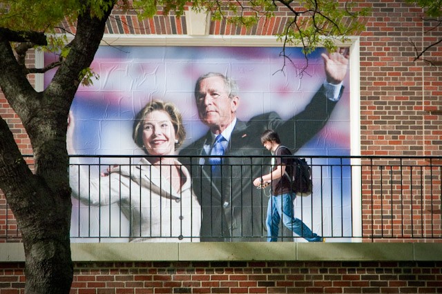 SMU junior Jonathon Lester walks past a large poster placed on the south side of the Umphrey Lee building this week for the George W. Bush Presidential Centers Building Afghanistan’s Future