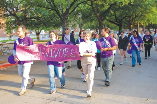 Three cancer survivors start the annual SMU Relay For Life event on the Boulevard Friday evening. More than 800 people participated in the walk.
