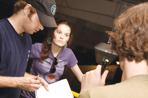 “Dread Factory” script supervisor, Weston Henry, actress Alex Williamson, and Mark Kerins go over blocking for a scene in a film. 