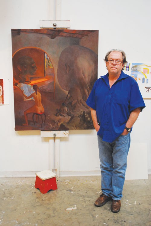 Professor Barnaby Fitzgerald, who has been teaching at SMU since 1984, stands with one of his recent paintings. 