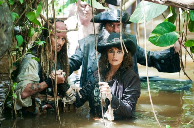 In this film publicity image released by Disney, Johnny Depp, left, Penelope Cruz, right, and Ian McShane, background are shown in a scene from, Pirates of the Caribbean