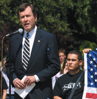 President R. Gerald Turner consoles the SMU community for the noon vigil at the Flagpole on Sept. 11, 2001. He urged members of the community to pull together. 