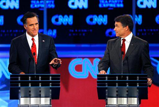 Republican presidential candidates former Massachusetts Gov. Mitt Romney, left, gestures as Texas Gov. Rick Perry watches during a Republican debate Monday, Sept. 12, 2011, in Tampa, Fla.