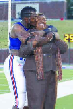Ja’Gared Davis and his mom, Gayla Davis, embrace after a home 