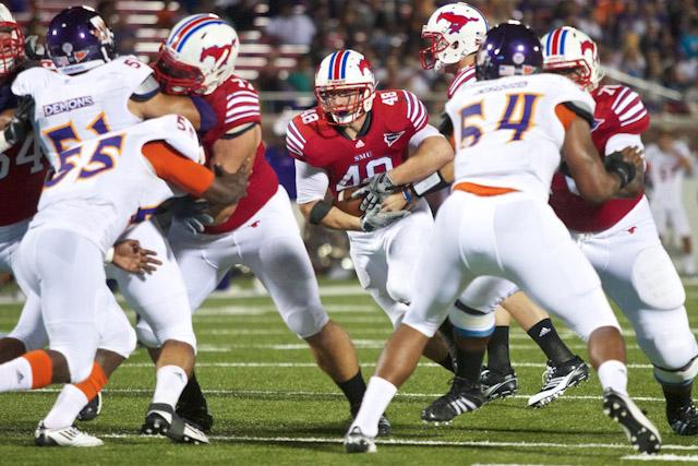 Junior running back Zach Line carries the ball through the Demon defense for a touchdown during play against Northwestern State University on Saturday evening in Ford Stadium. SMU won the game 40-7.