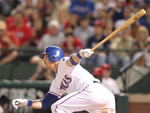 Texas Rangers center fielder Craig Gentry (23) hits his first home run, an inside the park home run, in the fourth inning, during their baseball game against the Seattle Mariners, Friday, Sept. 23, 2011, in Arlington, Texas. 