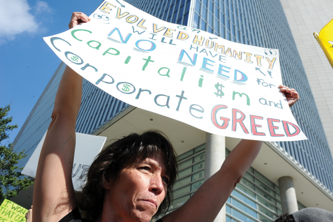 An Occupy Dallas protester joins in on the protest against “corporate greed.”