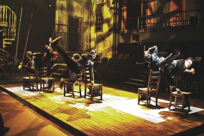Cast Members of WaterTower Theatre’s “Spring Awakening” perform a musical and dance number involving chairs and daring acrobatic moves.