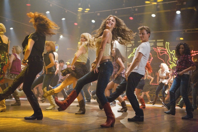Stars Julianna Hough and Kenny Wormald kick up their  heels in a fun,  upbeat musical number of Footloose.