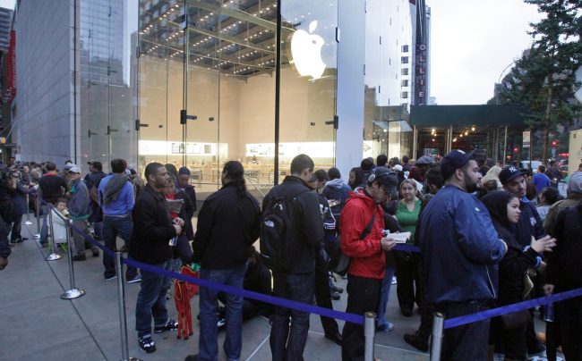 People wait in line to buy the new iPhone 4S outside the Apple store, on New York’s Upper West Side.