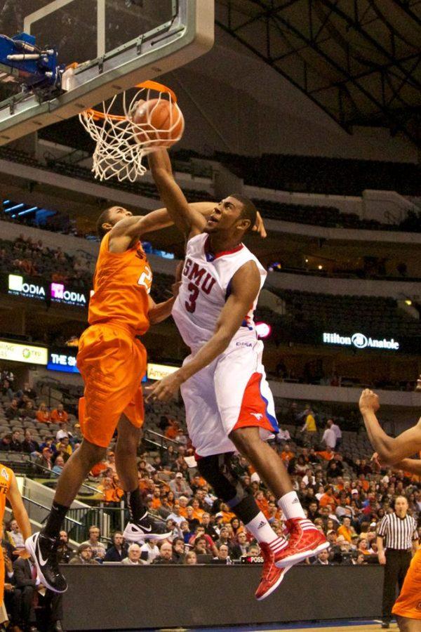 SMU Forward Leslee Smith dunks the ball against an Oklahoma State University opponent at the American Airlines Center Dec. 28, 2011. Including Saturday’s loss to Tulsa, the Mustangs are 10-11 overall.