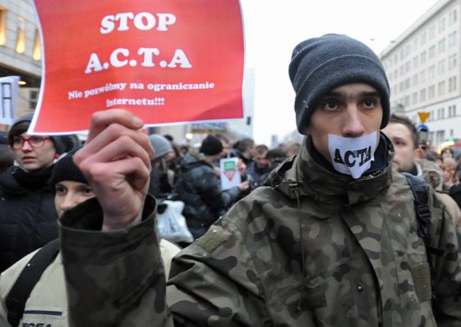 Internet activists protest against the international copyright agreement ACTA in front of the European Parliament office in Warsaw, Poland, Tuesday.
