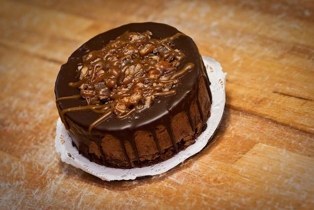 The Chocolate Oblivian Cake at Eatzi’s is a flourless chocolate cake with chocolate toffee mousse topped with chocolate glaze, caramel and chocolate toffee.