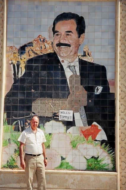 Harvey+Gough+in+front+of+a+Saddam+Hussein+mural+in+Iraq.