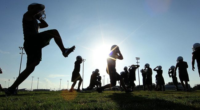 King players run through drills during the first day of high school football practice in Corpus Christi, Texas.