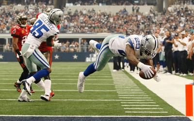 Dallas Cowboys running back DeMarco Murray (29) dives for touchdown while teammate Kevin Ogletree (85) defends against the Tampa Bay Buccanners during the first half of an NFL football game on Sunday in Arlington, Texas.